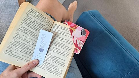 Reading book using fabric bookmark